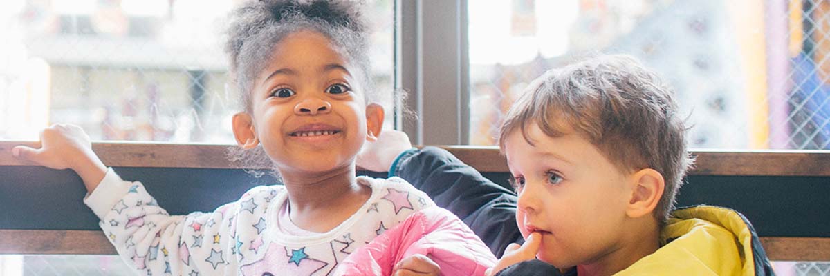 Two preschool students smiling at the camera