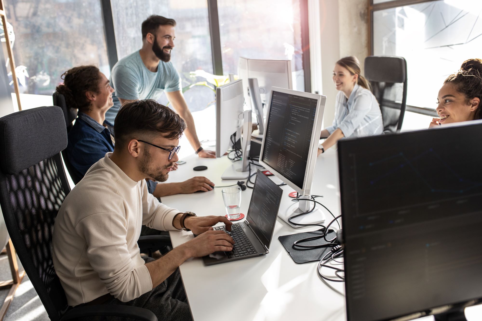 Group of people working on different type of computing devices